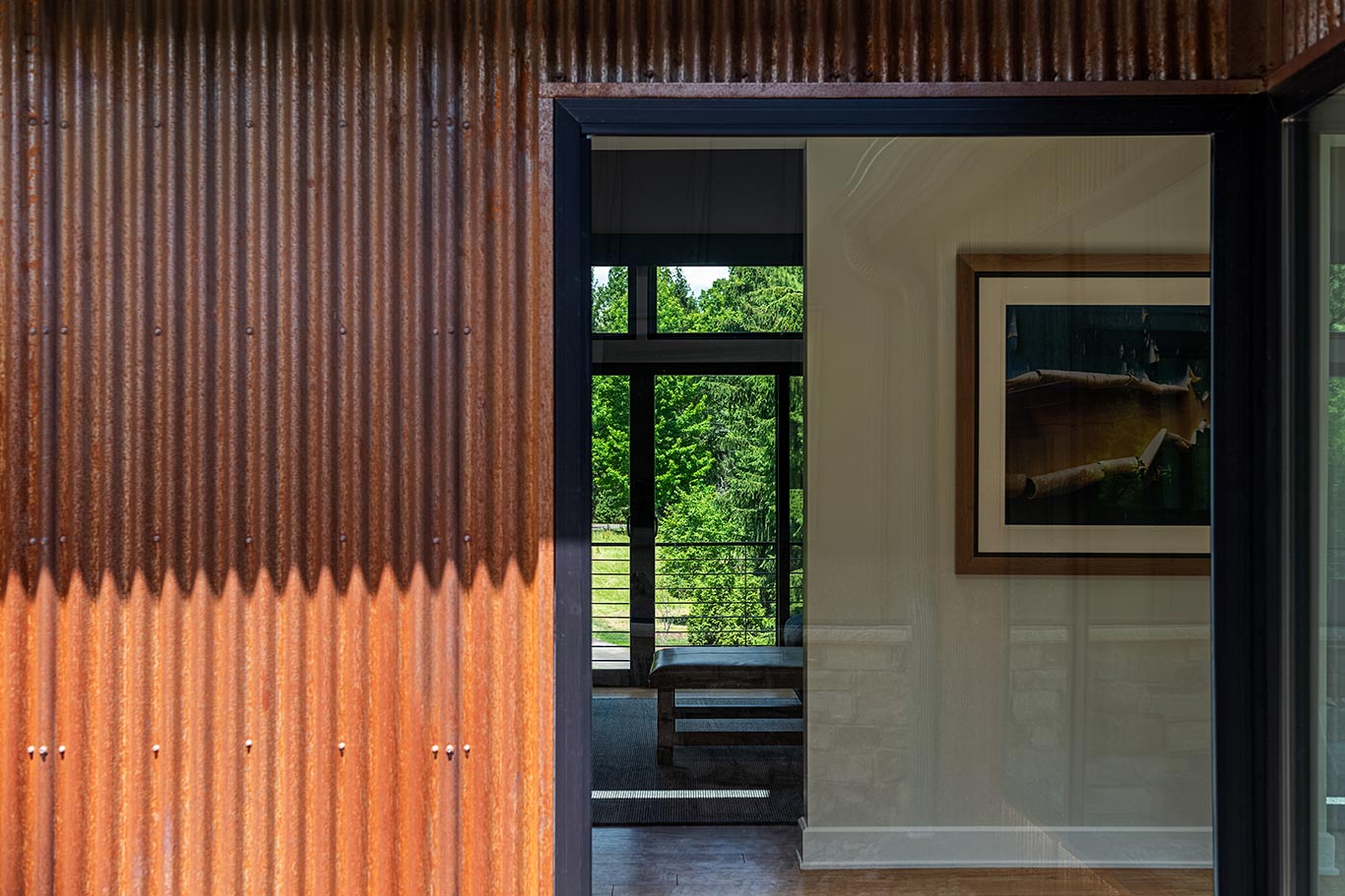 Corrugated metal siding abuts full-height window unit