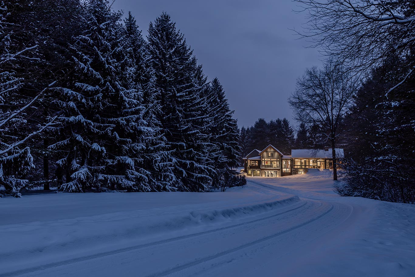 The home as viewed from the driveway on a wintry night